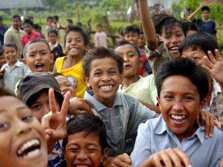 A group of happy children smiling into camera.