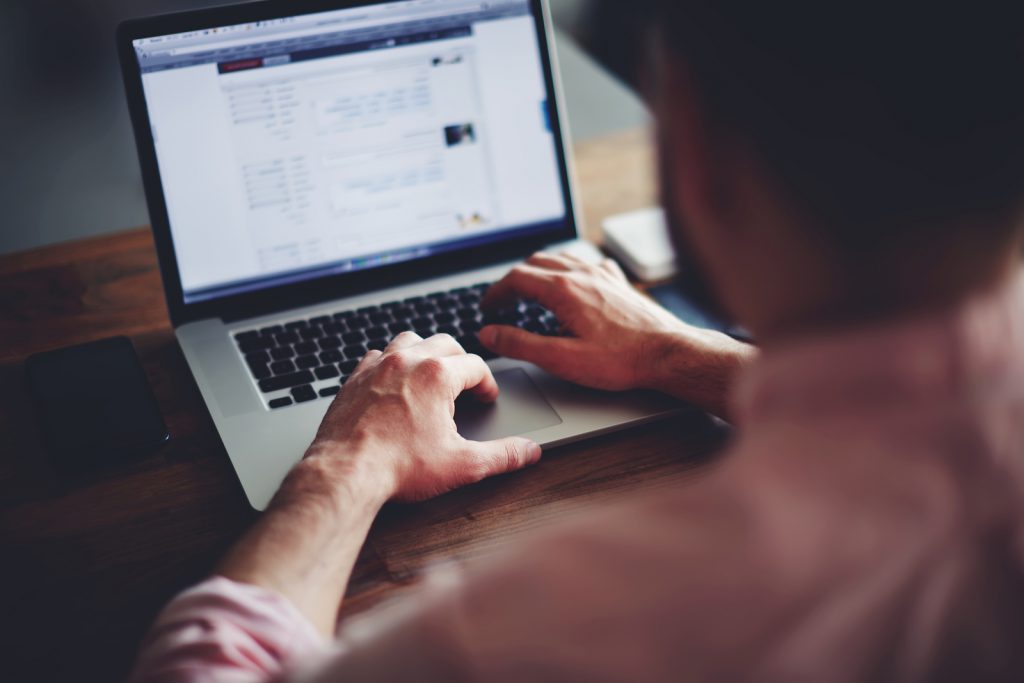 A man working on a laptop.