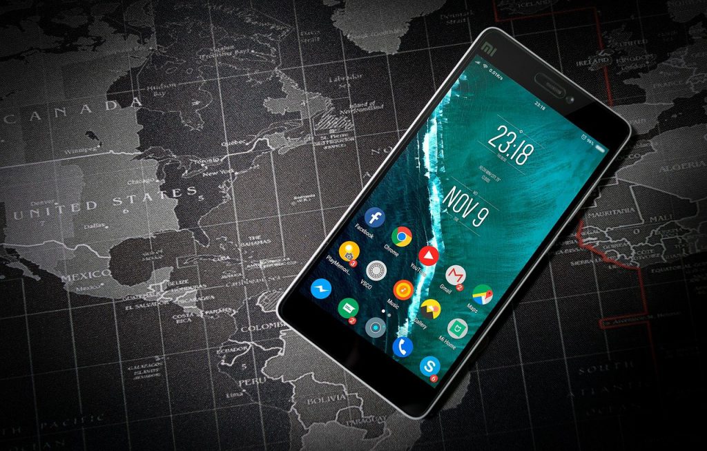 An android phone on top of a map.